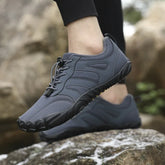 Grey low-profile sneakers with rugged sole, synthetic material, modern streetwear style