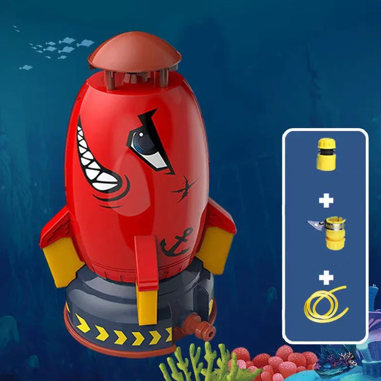 Red and yellow rocket-shaped toy submarine with cartoon face, set underwater with accessories shown.