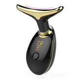 Black and gold electronic facial massager with LED display and curved top, modern design