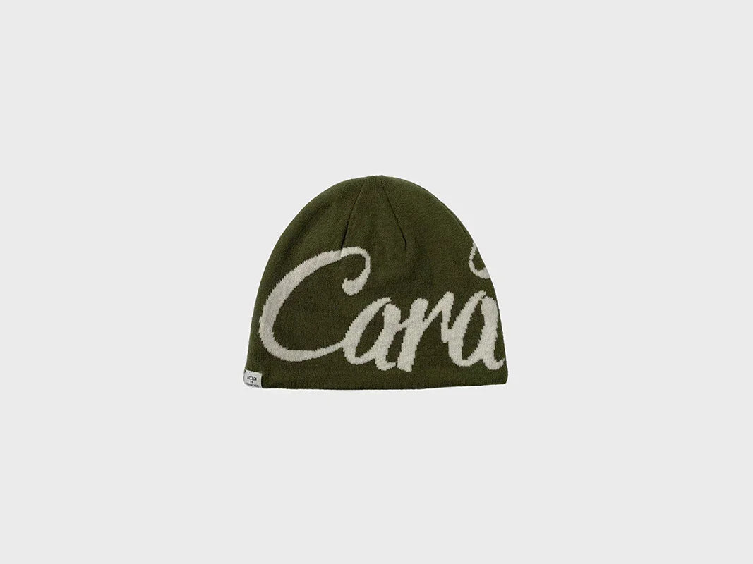 Olive green knit beanie with bold white script, soft streetwear accessory, relaxed fit