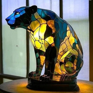 Stained glass panther-shaped lamp with vibrant blue, green, and yellow mosaic design.