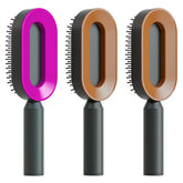 Three modern oval hairbrushes with colorful frames and black ergonomic handles