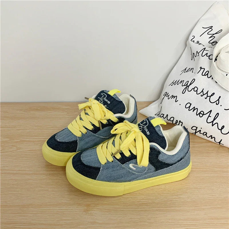 Yellow lace denim sneakers with blue color blocking and chunky rubber sole, casual streetwear style