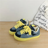 Yellow lace denim sneakers with blue color blocking and chunky rubber sole, casual streetwear style