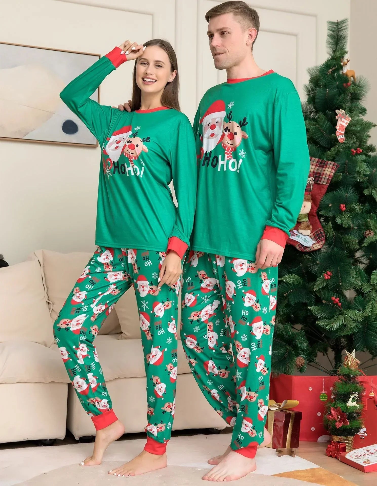 Couple wearing green Christmas pajama set with Santa and reindeer print, relaxed fit.