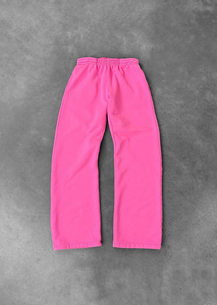 Bright pink fleece sweatpants with elastic waistband, relaxed fit, laid flat on gray background