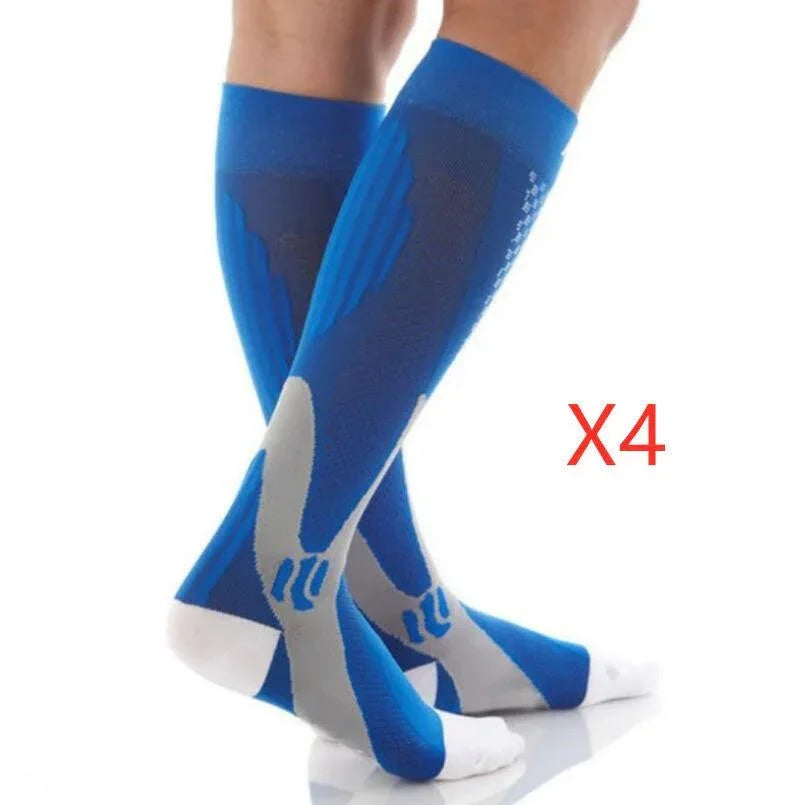 Blue and grey knee-high compression socks with a snug athletic fit, worn by a model.