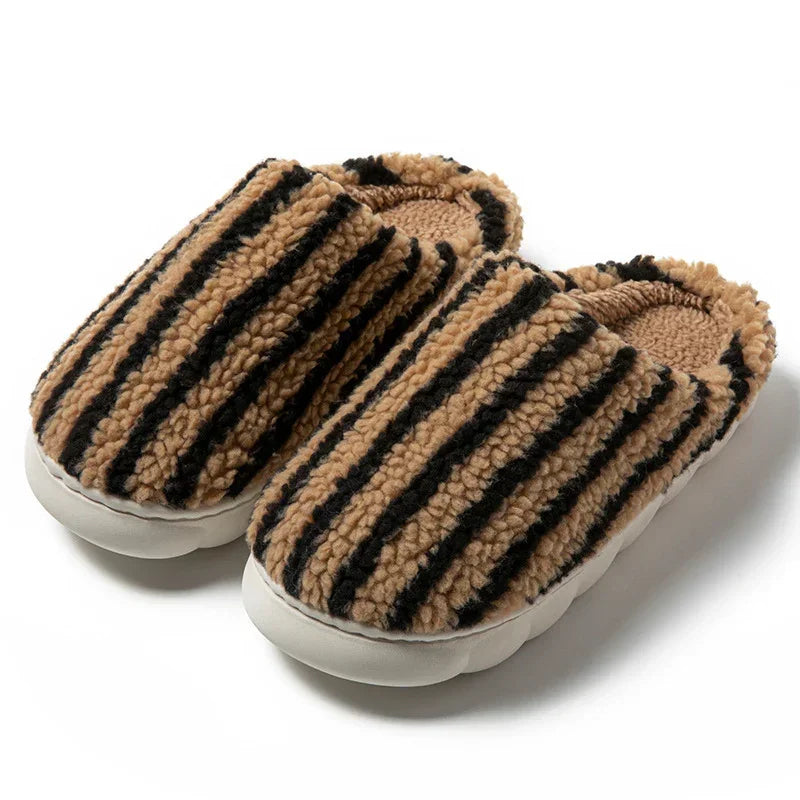 Cozy slip-on slippers with tan and black striped sherpa material and cushioned sole