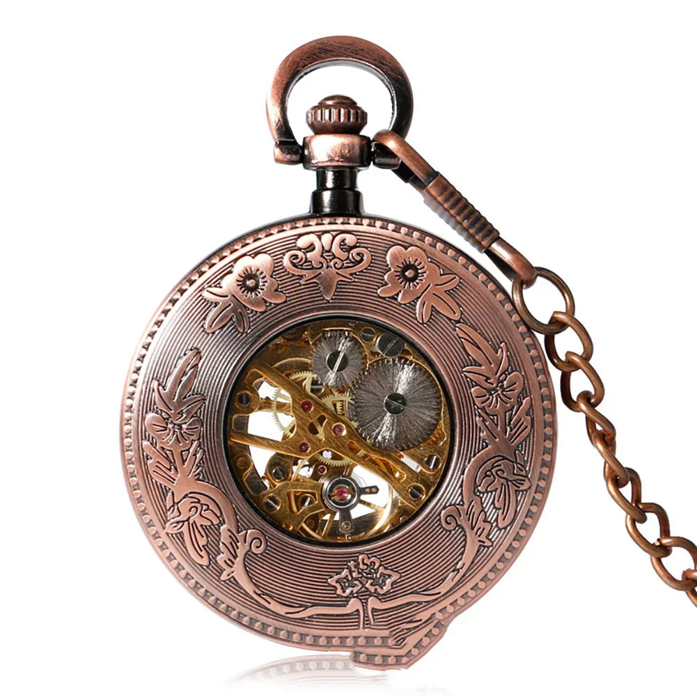 Antique bronze pocket watch with floral engraving and visible mechanical gears