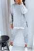 Woman wearing light gray oversized sweatshirt and jogger pants set, cotton material, relaxed fit streetwear.