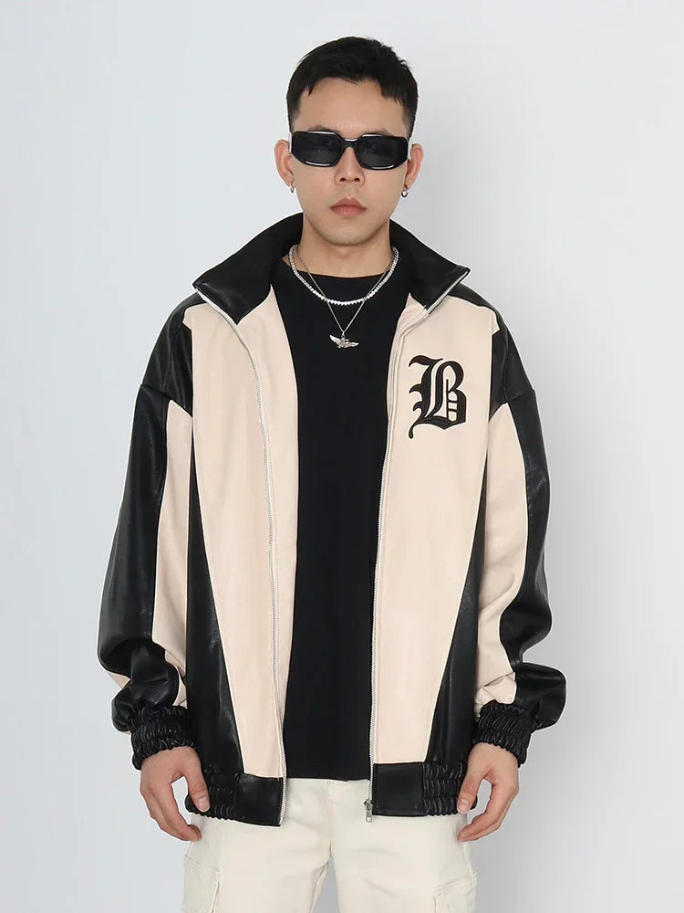 Man wearing black and beige colorblock streetwear jacket with relaxed fit and bold graphic detail