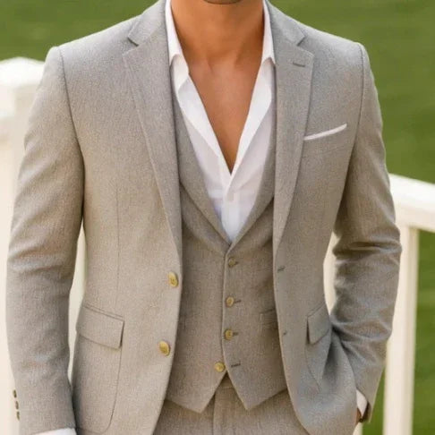 Light grey tailored suit with notch lapels, single-breasted vest, and white dress shirt