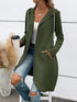 Woman wearing long olive green zip-up hoodie with pockets, white tank top, ripped blue jeans