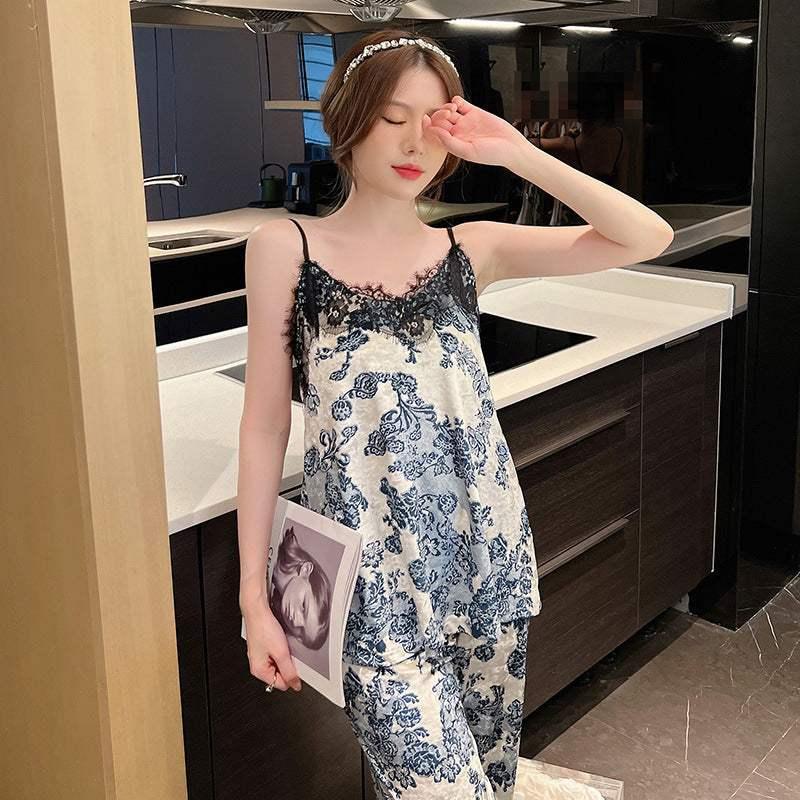 Woman wearing blue and white floral satin pajama set with lace trim and relaxed fit