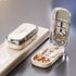 Beige and clear plastic pill organizer with mirror, shown open and closed on reflective surface
