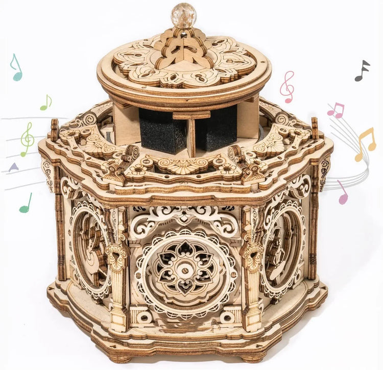 Intricate wooden music box with carved details and decorative wheels, vintage style.