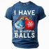 Blue fitted t-shirt with bold Christmas graphic and text, featuring colorful ornament print.