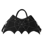 Black faux leather handbag with spider web stitching, batwing shape, detachable strap, gothic style.