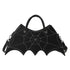 Black faux leather handbag with spider web stitching, batwing shape, detachable strap, gothic style.