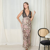 Woman wearing a sleeveless leopard print and floral maxi dress with black lace bodice, slim fit.