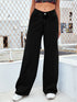 Woman wearing high-waisted black wide-leg jeans, relaxed fit streetwear style