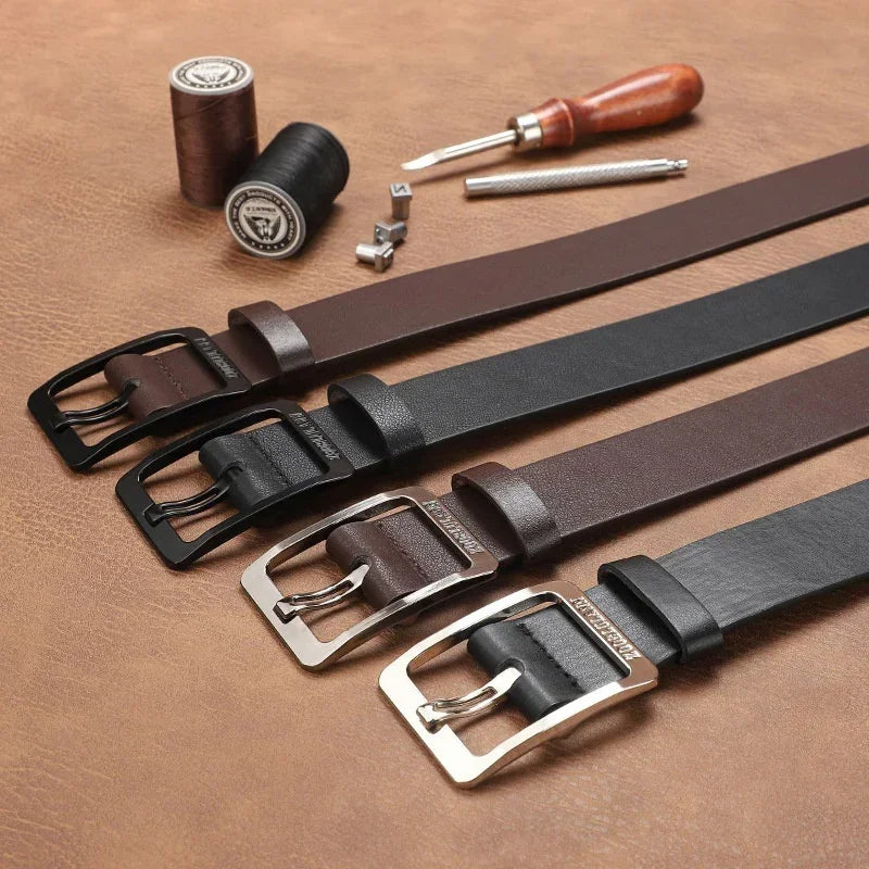 Assorted brown and black leather belts with metal buckles, classic fit, on a tan surface.