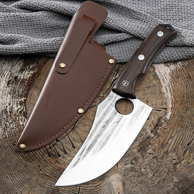 Stainless steel curved knife with dark wood handle and brown leather sheath on rustic wood