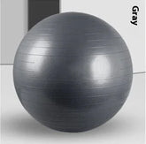 Gray fitness exercise ball with textured, non-slip surface, indoor minimalist setting