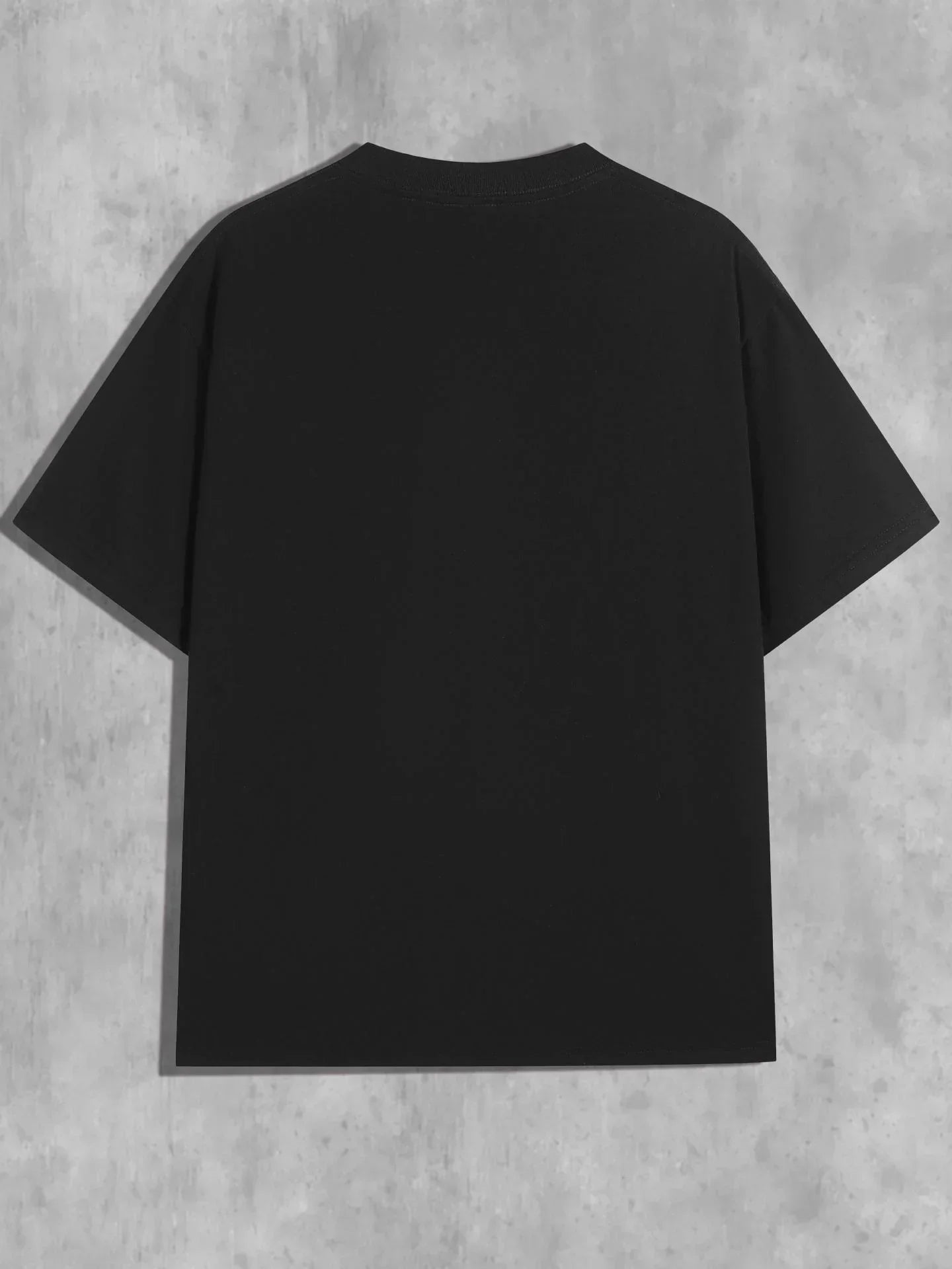 Back view of plain black oversized short sleeve t-shirt on concrete background