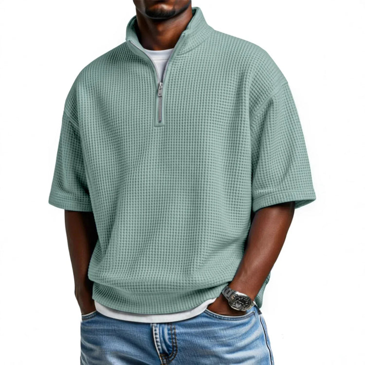 Light green waffle knit short sleeve pullover with zip collar, relaxed fit, paired with jeans