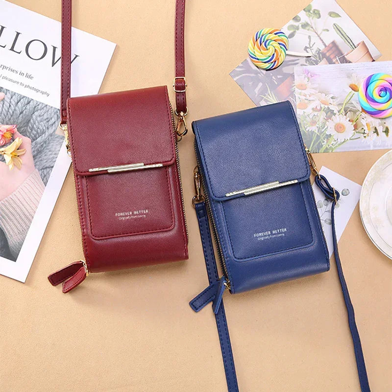 Red and blue faux leather crossbody phone bags with slim, adjustable straps and gold accents.