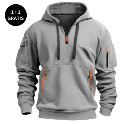 Gray pullover hoodie with orange zipper accents, pocket details, and relaxed fit.