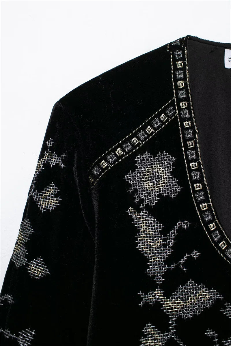 Black velvet top with silver cross-stitch embroidery and studded V-neck detail