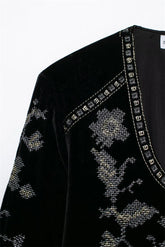 Black velvet top with silver cross-stitch embroidery and studded V-neck detail
