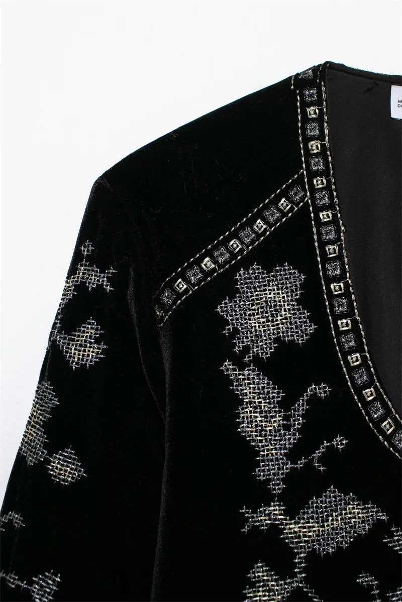 Black velvet top with silver cross-stitch embroidery and studded V-neck detail