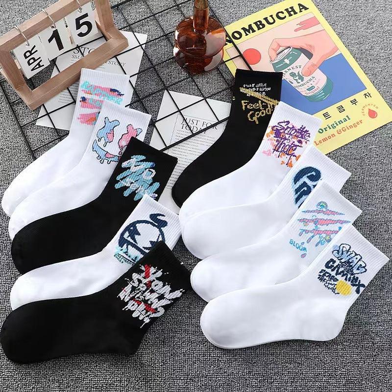 Assorted black and white streetwear socks with colorful graphic designs, cotton crew fit.