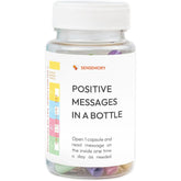 Clear plastic bottle containing assorted pastel paper capsules with positive messages label.
