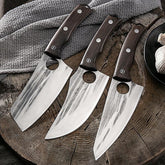 Three stainless steel chef knives with dark wood handles and large blade holes, displayed on wooden surface