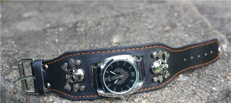 Black leather wide wristwatch with skull accents, silver buckle, and orange stitching