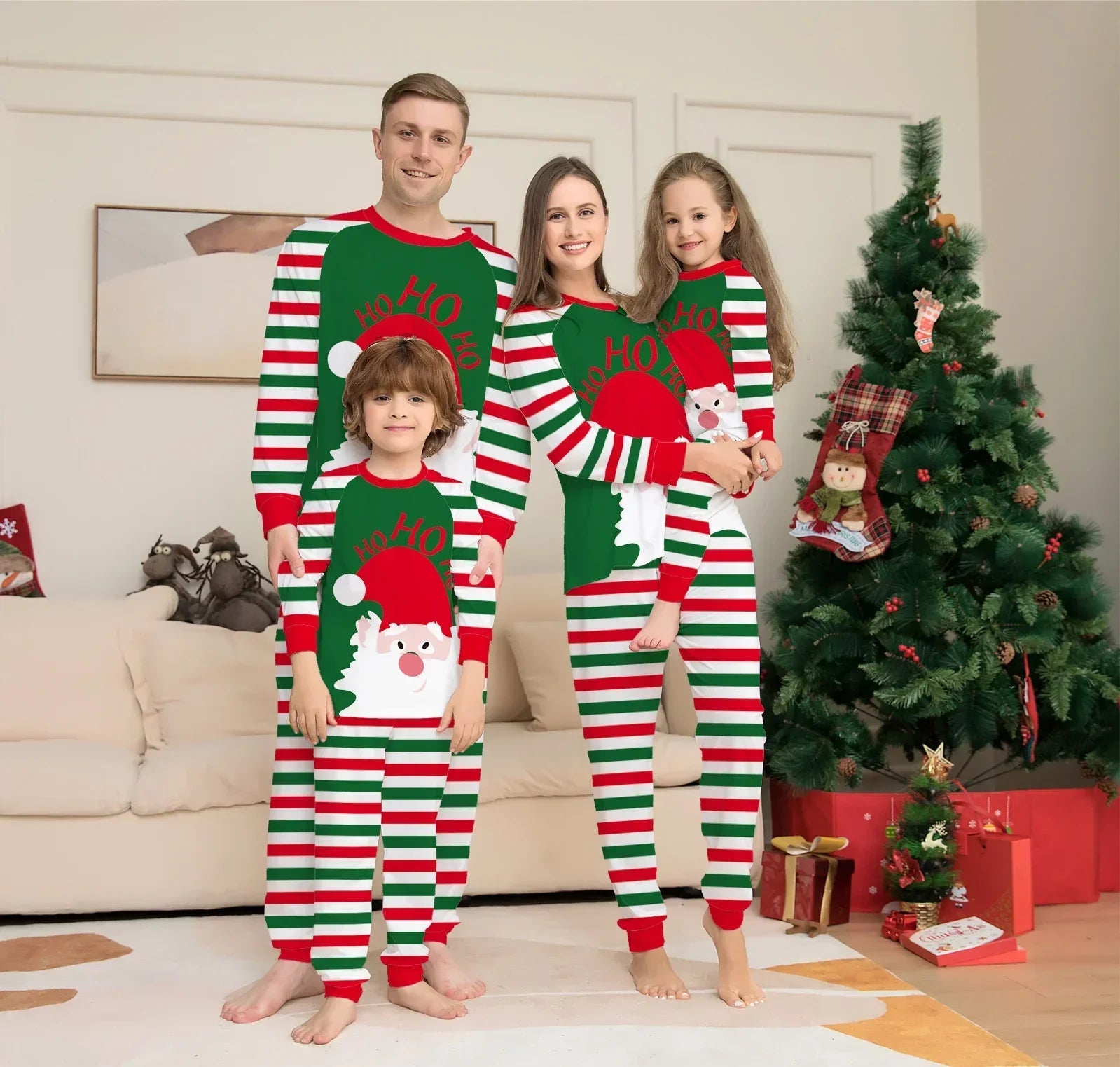 Family in matching striped Christmas pajamas with Santa print, festive red, green, and white colors, relaxed fit.