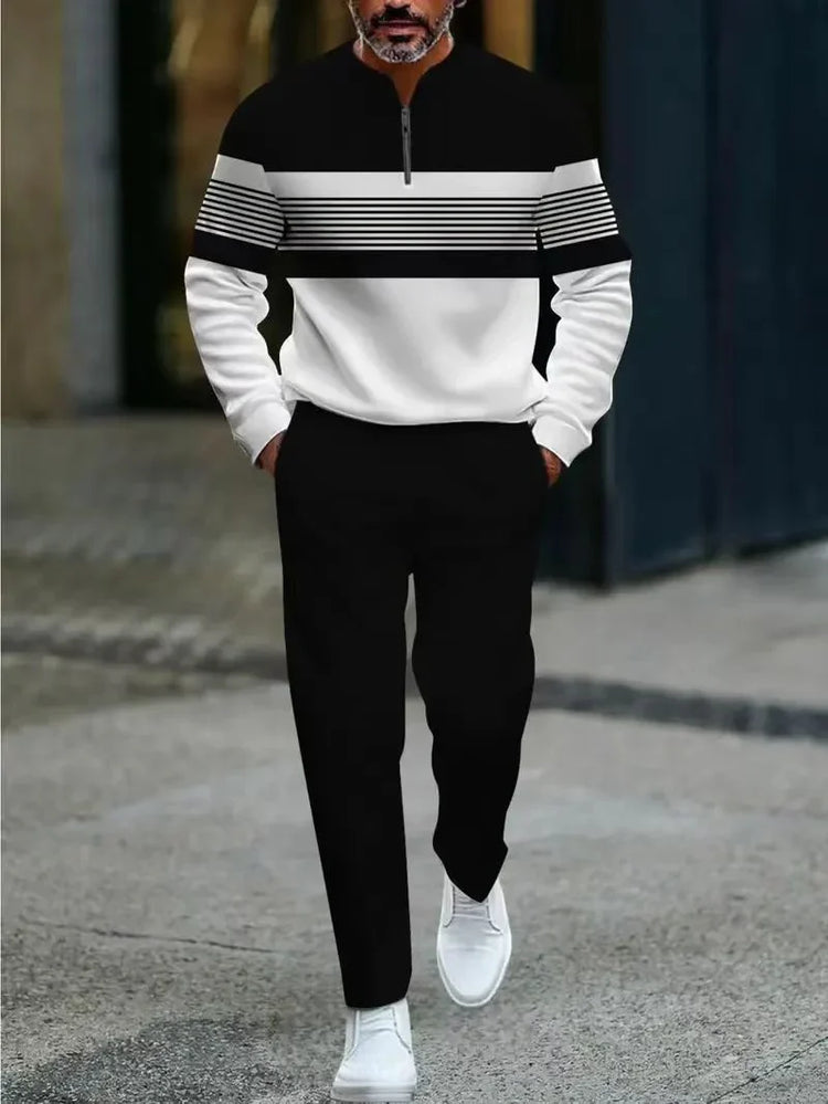 Man wearing black and white striped pullover, black pants, white sneakers, modern streetwear style