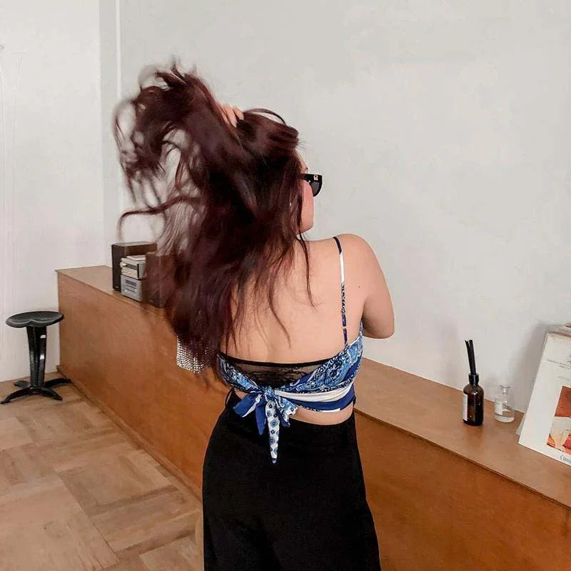 Woman wearing a blue bandana crop top with black wide-leg pants, relaxed fit, casual style