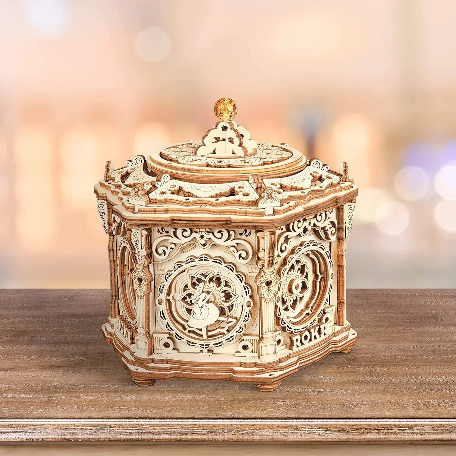Intricate laser-cut wooden jewelry box with ornate scrollwork and a golden knob lid
