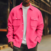 Man wearing oversized hot pink button-up shirt jacket with flap pockets, casual streetwear style