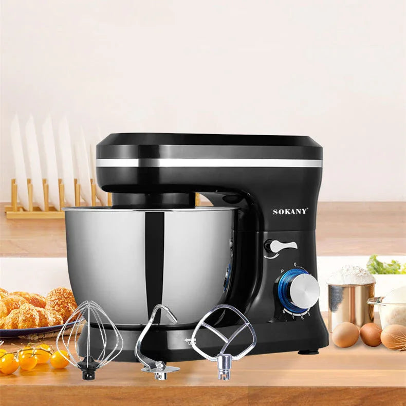 Black and silver stand mixer with stainless steel bowl and three metal attachments on a kitchen counter