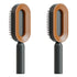 Modern oval hair brush with brown plastic frame, black bristles, and ergonomic handle