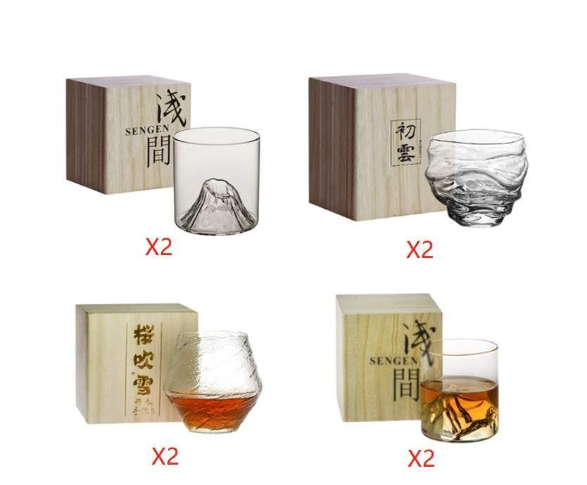Set of unique designer whiskey glasses with textured clear glass, shown next to wooden gift boxes.