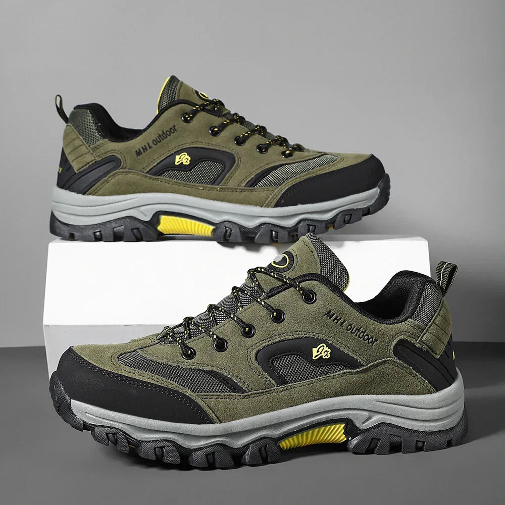 Olive green and black rugged outdoor sneakers with yellow accents, mesh panels, and thick soles