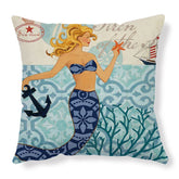 Decorative pillow with blue patterned mermaid design, nautical theme, and vintage accents