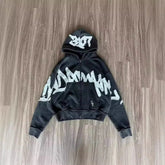 Black zip-up hoodie with oversized graffiti print, relaxed fit, cotton streetwear style